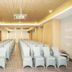 Lamora Kota Lama Surabaya meeting room with rows of white chairs and wood ceiling