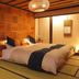 Ryokan Hanaougi Bettei Iiyama in Takayama: tatami room with bed, shoji screens and warm lighting