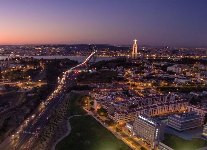 Mercure Lisboa Almada with panoramic dusk view over Almada, city lights and the illuminated 25 de Abril Bridge