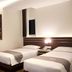 Neotel Hotel City Centre room in Tanjung Redeb with two single beds and cityscape wall art