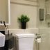 Campagne Hotel And Residence - Sha Plus bathroom with shower, toilet, sink and wall-mounted soap dispenser in Pathum Thani