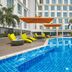 Kingsford Hotel Manila Bay in Manila with a blue pool, orange umbrellas, and lounge chairs