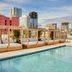 Rooftop pool at AC Hotels by Marriott San Diego Downtown Gaslamp Quarter with cabana daybeds and city skyline