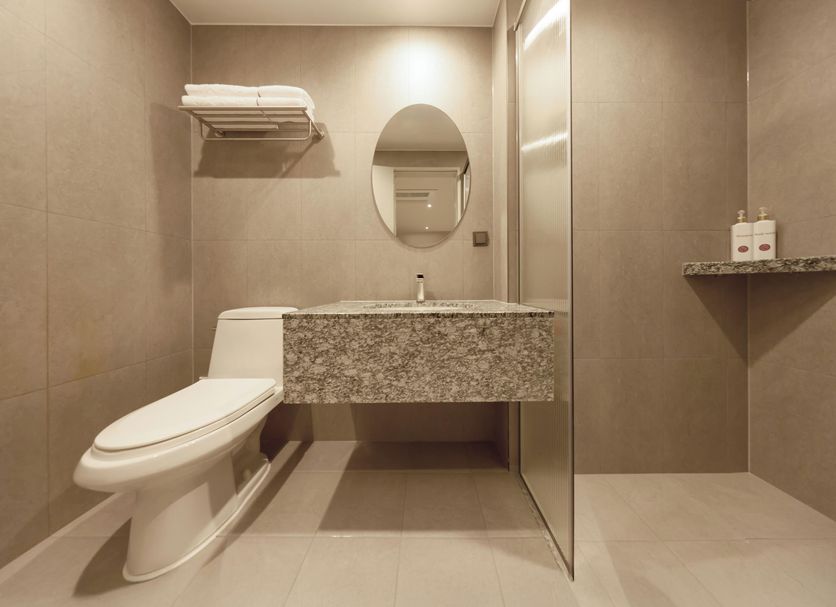 Capace Hotel Gangnam Seoul bathroom with stone sink, wall-mounted toilet and glass shower