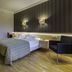 Spa Tervis in Pärnu guest room with double bed, striped wall, and modern chair