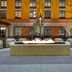 Home2 Suites by Hilton Orlando at FLAMINGO CROSSINGS Town Center fire pit courtyard seating in Bay Lake