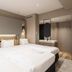 Richmond Hotel Obihiro Ekimae guest room with three beds, modern lighting and a vanity area in Obihiro