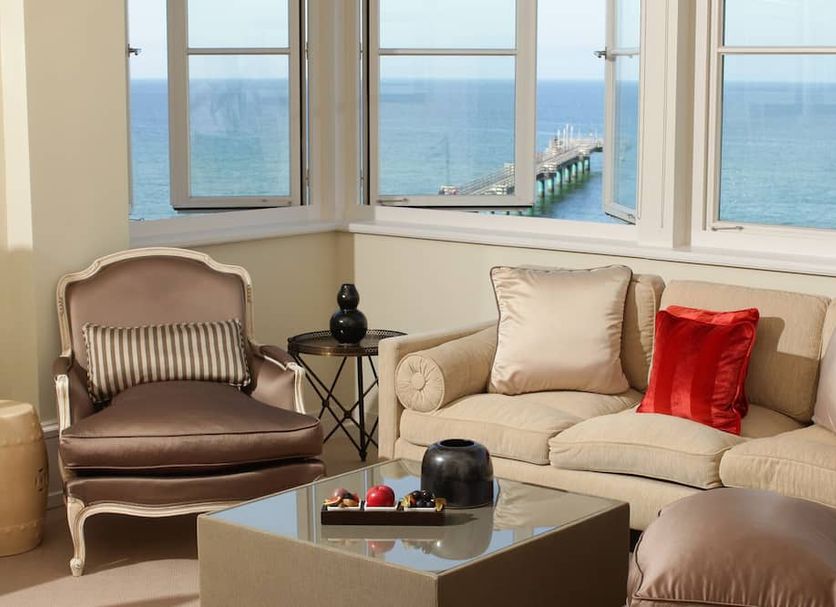 Grand Hotel Heiligendamm in Bad Doberan lounge with sea-view windows, sofa, armchair and coffee table