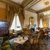 Ashdown Park Hotel & Country Club in East Grinstead lounge with chandeliers, tall drapes and armchairs