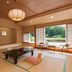 Shima Grand Hotel in Nakanojo: tatami room with low table and large windows overlooking greenery