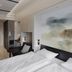 Valo Hotel & Work Helsinki room in Helsinki with bed, workspace, dining area and abstract wall art