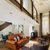 Holmes Hotel London in London suite with mezzanine, leather sofa, armchairs and chandelier