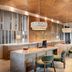 Secrets Tides Punta Cana reception area with marble desk, teal chairs and modern pendant lights in Uvero Alto