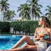 Hotel Jaragua Veracruz poolside woman lounging with drink beside palm trees and fountain