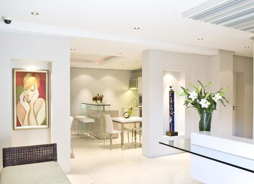 Atlantic Affair Boutique Hotel Cape Town lobby with dining area, artwork, and white floral arrangement