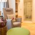 Romantik Hotel Hirschen in Parsberg: cozy lounge chair, ottoman and open bathroom doorway