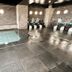 Hotel Route-Inn Kanazawa Ekimae indoor bath area with tiled pool and shower stations in Kanazawa