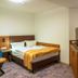 Trip Inn City Hotel Giessen room with bed, TV, desk and balcony door in Gießen