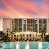 Hilton Grand Vacations Club Parc Soleil Orlando pool with resort tower and sunset sky