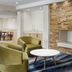 Fairfield Inn & Suites by Marriott Harrisburg Hershey lobby with stone fireplace, green chairs and coffee table