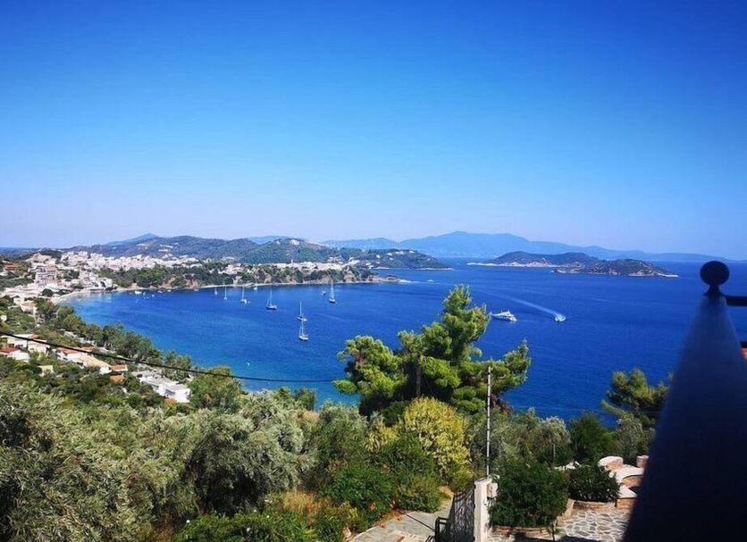 Fiorella Sea View in Katsaros overlooking a blue bay with sailboats and hillside greenery