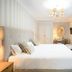 Hotel La Fonda, Benalmádena bedroom with king bed, chandelier, desk and balcony doors
