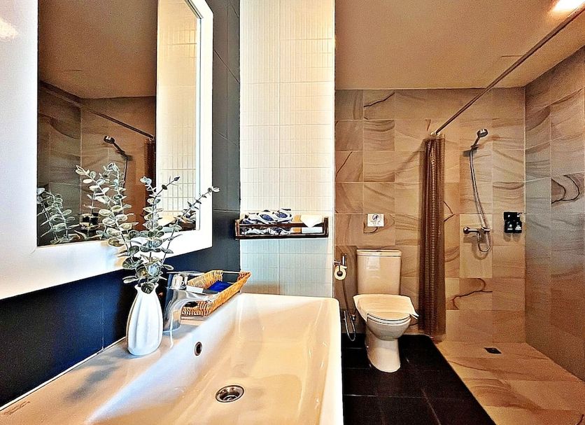 The Sixteenth Naiyang Beach Hotel SHA+ bathroom with sink, toilet, and walk-in shower in Sakhu