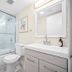 Riverwatch Apartments By Lowkl bathroom in Jensen Beach with glass shower, vanity, toilet and mirror