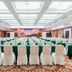 Grand Bayview Hotel Ningbo banquet hall set for an event with rows of chairs and green tablecloths
