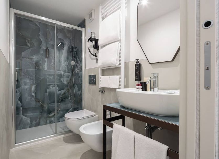Albergo Cavalletto & Doge Orseolo Venice bathroom with glass shower, bidet, and vessel sink