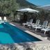 Casa Siciliana Altarbiah in Trabia: outdoor pool with sun loungers, umbrellas, and mountain views