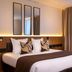 Hotel Du Port in Nogent-sur-Marne guest room with king bed, mirrored headboard, and floor-to-ceiling window