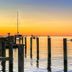 Tilghman Island Inn on Tilghman Island with sunset harbor view and boats on calm water