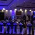 Ashbourne House Hotel, Ashbourne: banquet hall with rows of chair-covered seats and a lit stage