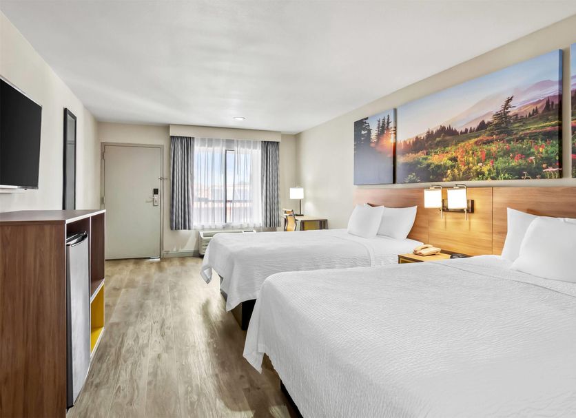 Days Inn by Wyndham Fontana / Rialto guest room with two beds and a window view