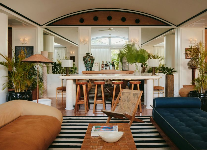 Palm Heights, North Side: stylish lounge with striped rug, bar seating, and tropical plants