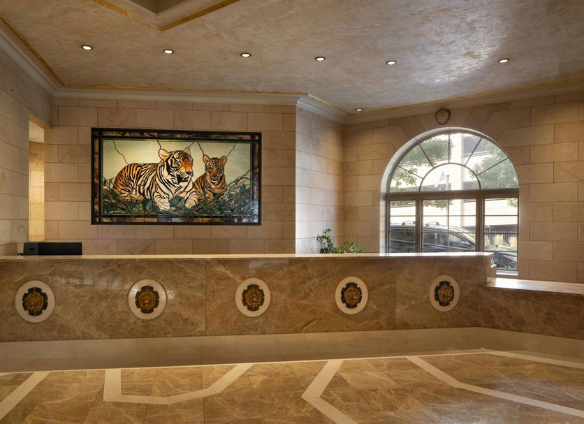 The Davenport Tower, Autograph Collection lobby front desk in Spokane with tiger artwork and arched window