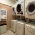 Toyoko Inn JR Yokohama sen Sagamihara Ekimae laundry room with stacked washers and dryers in Sagamihara