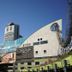 Tosei Hotel Cocone Kanda in Tokyo with modern amusement park structures against a blue sky