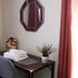 The Marquette Hotel in Madison room with desk, folded towels, potted plant, and wall mirror