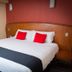 Hotel Santa Maria in Mexico City: double bed with red accent pillows and wood headboard