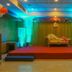 Hotel Grand Palace in Chennai banquet hall with stage, gold sofa, and colorful uplighting