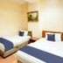 Casavilla Travellers Lodge Pudu in Kuala Lumpur guest room with two single beds and wall art