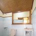 Tanjung Alam Hotel bathroom in Buleleng with toilet, sink, tiled walls and patterned floor