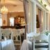Hotell Björkhaga in Mullsjö dining room with white table settings and chandelier