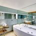 The Henry Jones Art Hotel, Hobart: modern bathroom with freestanding bathtub, double sinks and mirrored wall