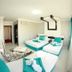 Park Vadi Hotel in Diyarbakır guest room with three beds and striped seating area