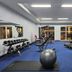 Fitness room at d'primahotel Kualanamu Medan in Medan with dumbbells, treadmills and exercise ball