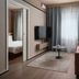 Sky Hotel Apartments Stockholm room with sofa, TV, and large window in Stockholm