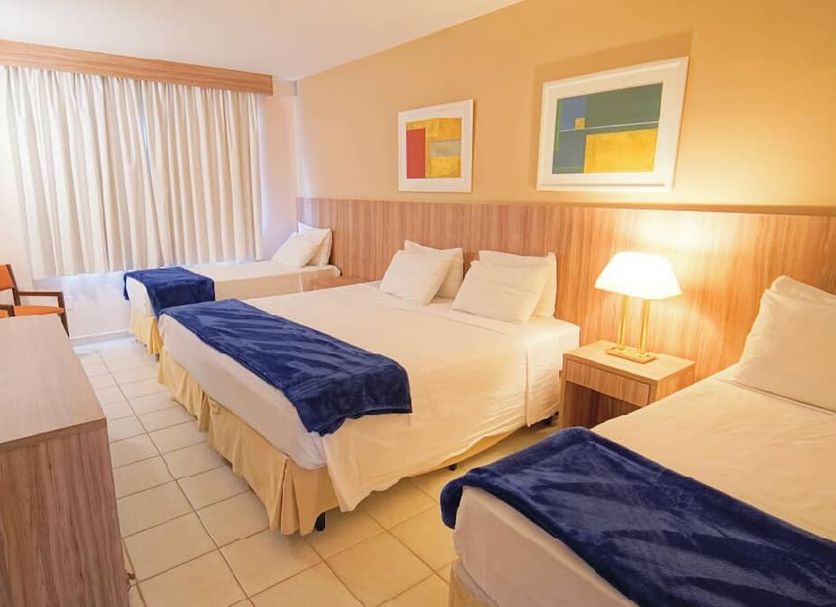 Eldorado Atibaia Eco Resort guest room with three beds and bright window seating in Atibaia